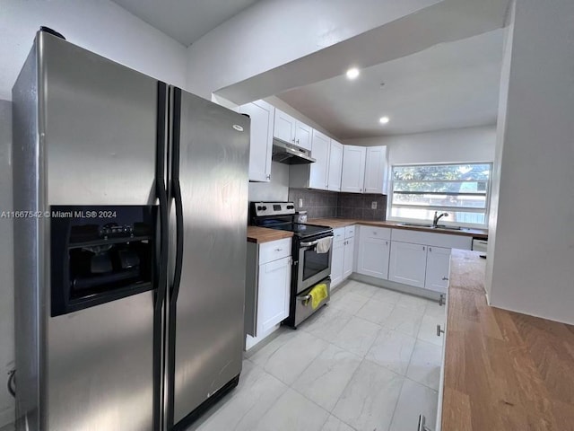 kitchen featuring sink, white cabinetry, stainless steel appliances, backsplash, and butcher block countertops