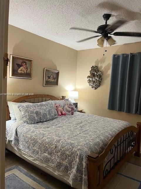 bedroom featuring ceiling fan and a textured ceiling