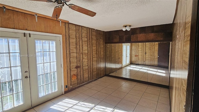 3230 N 23rd Ave, Hollywood, FL 33020 - empty room with light tile patterned floors, french doors, a textured ceiling, and ceiling fan