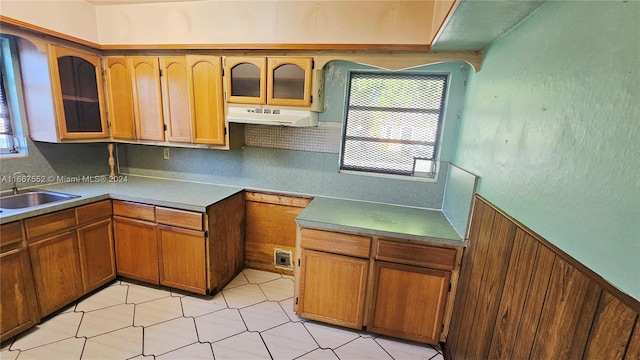 3230 N 23rd Ave, Hollywood, FL 33020 - kitchen with tasteful backsplash, glass insert cabinets, a sink, under cabinet range hood, and brown cabinets
