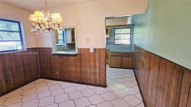 3230 N 23rd Ave, Hollywood, FL 33020 - unfurnished dining area with wood walls, a wainscoted wall, and a notable chandelier