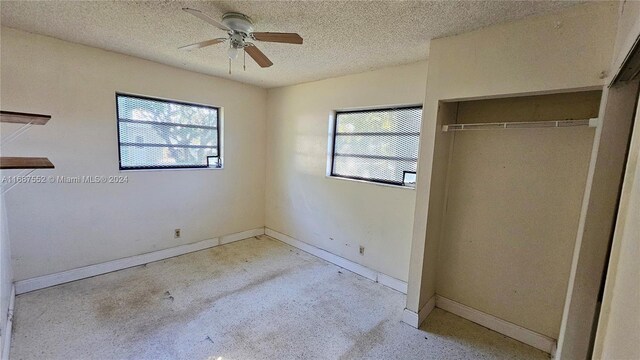 3230 N 23rd Ave, Hollywood, FL 33020 - unfurnished bedroom with a closet, baseboards, ceiling fan, and a textured ceiling