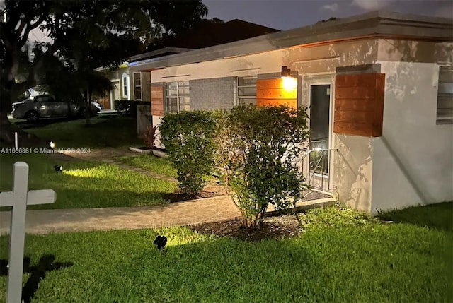 view of side of property with a yard