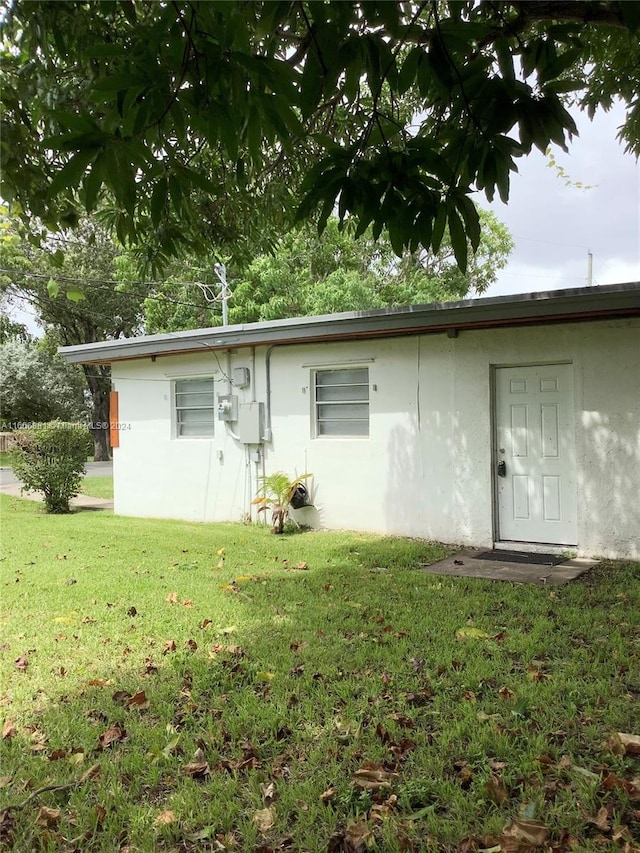 back of property featuring a lawn