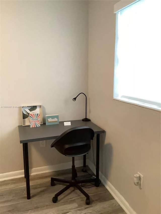 office area with a healthy amount of sunlight and hardwood / wood-style flooring