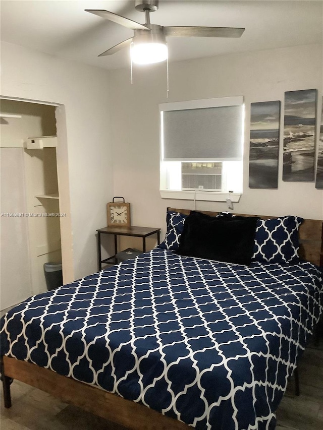 bedroom featuring ceiling fan, hardwood / wood-style flooring, and ensuite bathroom