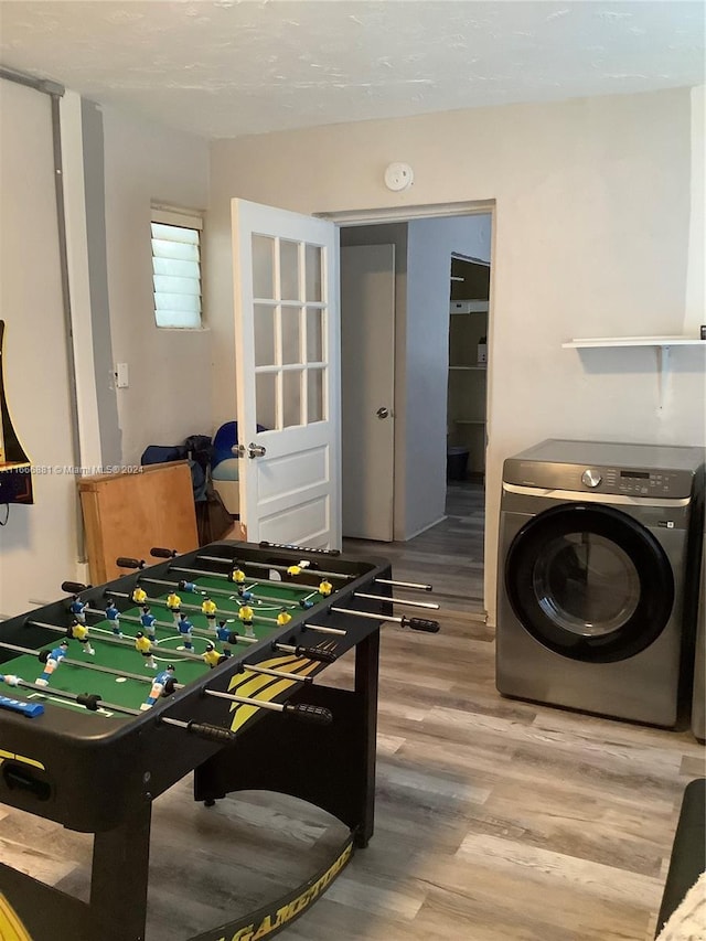 game room featuring wood-type flooring and washer / clothes dryer