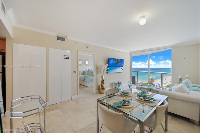 dining space featuring visible vents, floor to ceiling windows, and crown molding