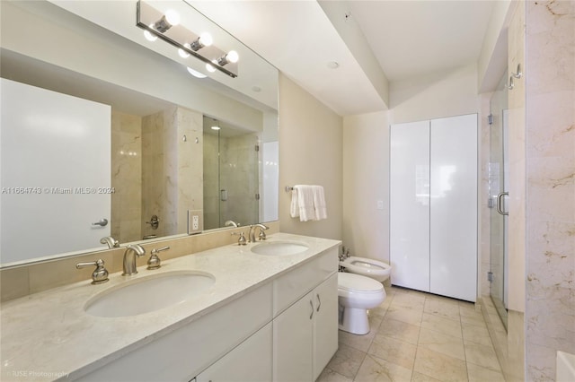 bathroom featuring toilet, a bidet, a sink, and a stall shower