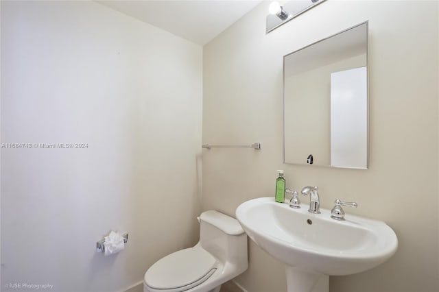 half bath featuring a sink and toilet