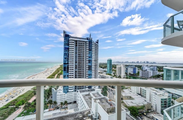 balcony with a water view and a beach view