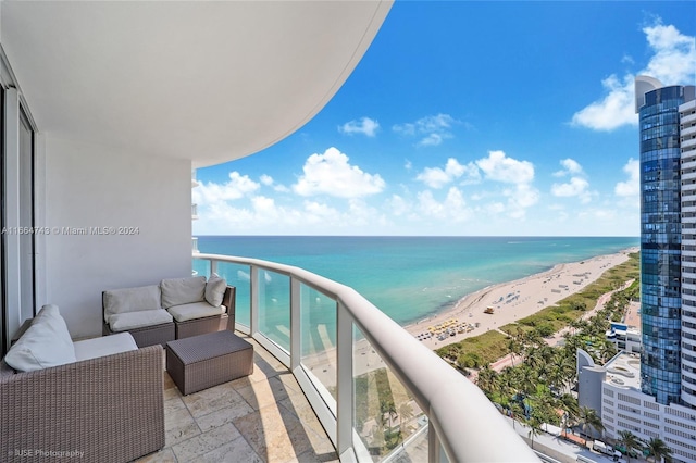 balcony with a beach view, an outdoor living space, and a water view