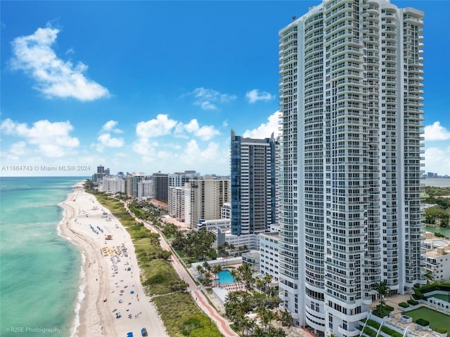 bird's eye view with a city view, a view of the beach, and a water view