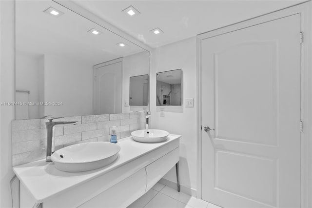 bathroom with vanity, decorative backsplash, and tile patterned floors