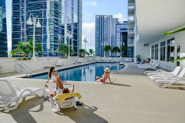 view of swimming pool featuring a patio area