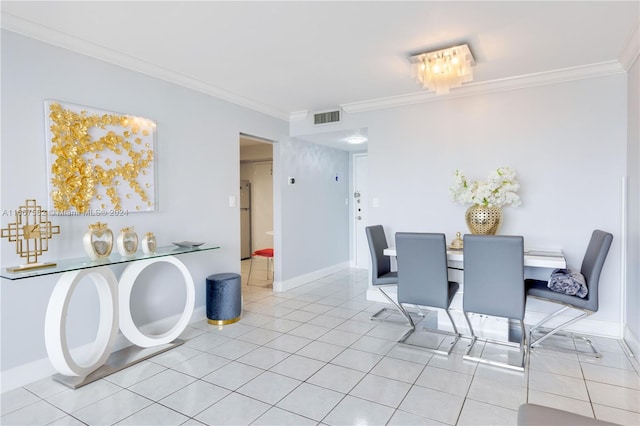 dining room featuring light tile patterned floors and crown molding