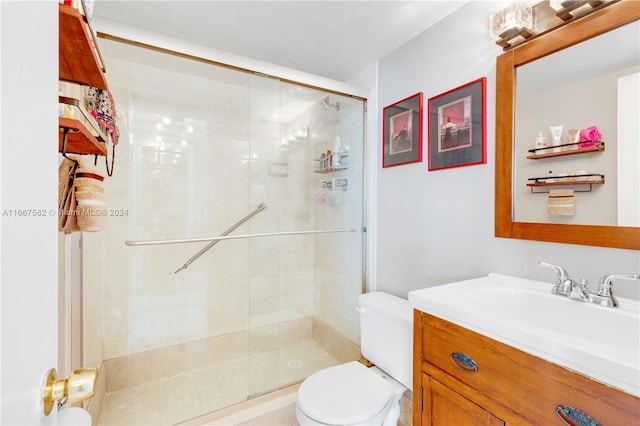 bathroom featuring vanity, toilet, and walk in shower