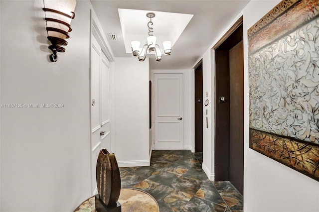 hallway with a notable chandelier