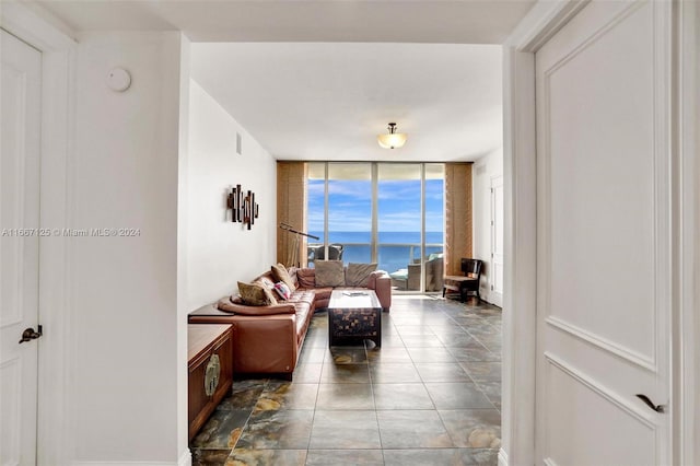 living room with a water view and expansive windows