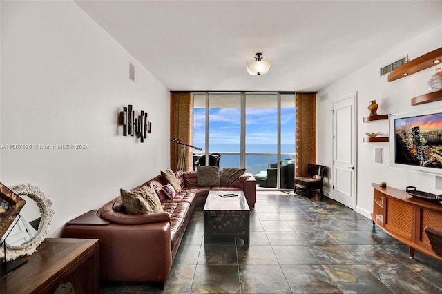 living room featuring floor to ceiling windows