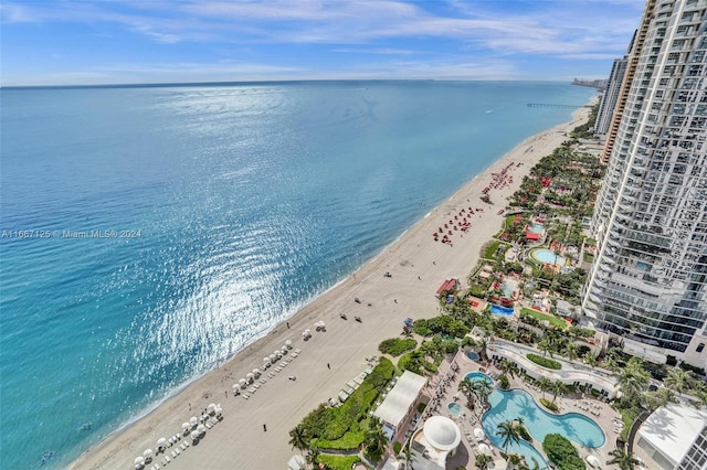 bird's eye view with a water view and a beach view