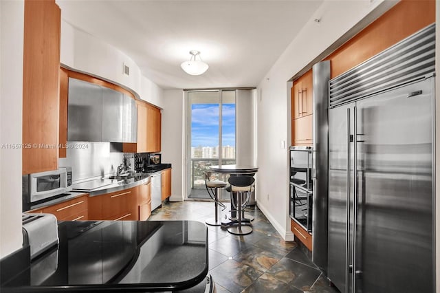 kitchen with appliances with stainless steel finishes, tasteful backsplash, and stainless steel counters