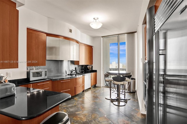 kitchen with high end fridge and backsplash