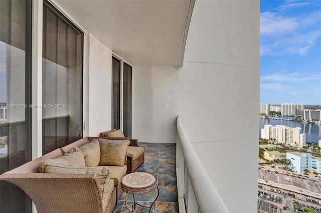 balcony featuring a water view and a view of city