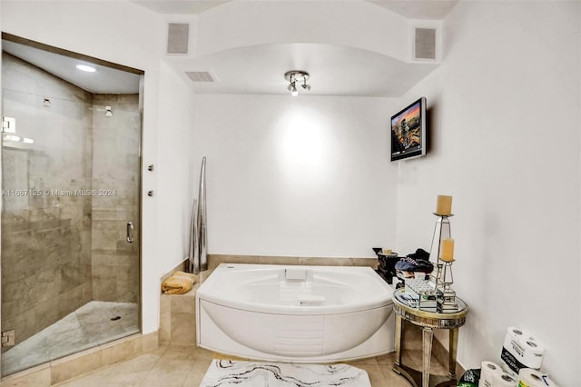 bathroom with separate shower and tub and tile patterned flooring