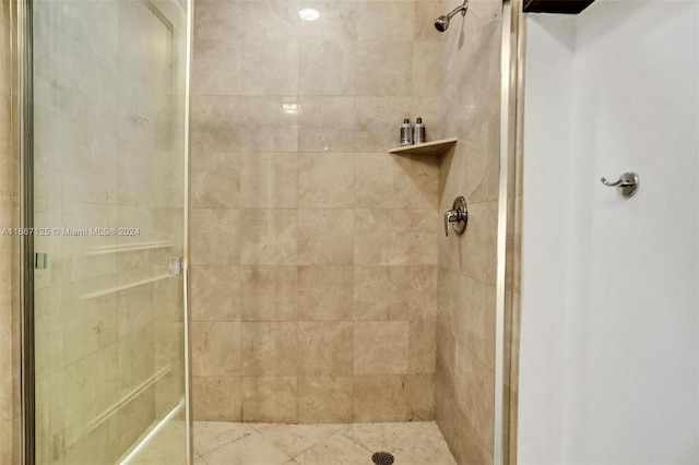 bathroom with a shower with shower door