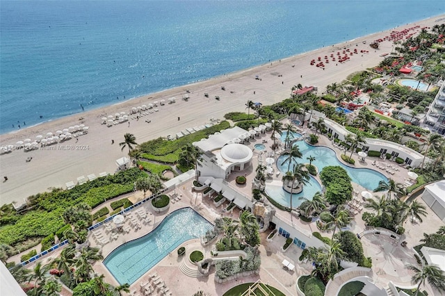 drone / aerial view with a water view and a beach view