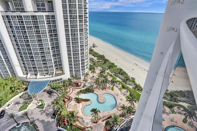 bird's eye view featuring a water view and a beach view