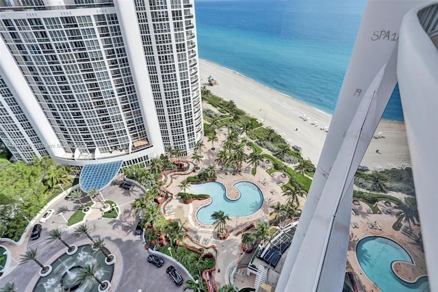 drone / aerial view featuring a water view and a view of the beach