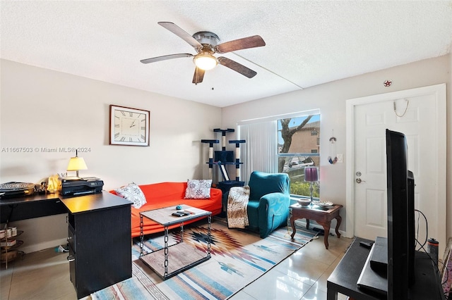 tiled office featuring ceiling fan and a textured ceiling