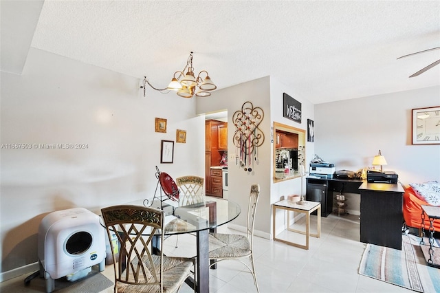 dining area featuring a textured ceiling, ceiling fan with notable chandelier, and light tile patterned floors