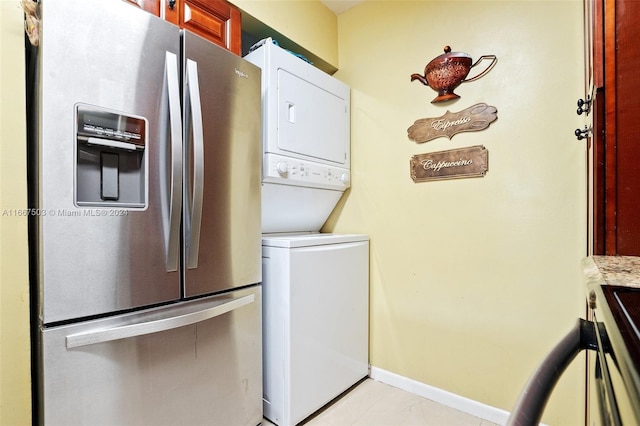 washroom featuring stacked washer and clothes dryer