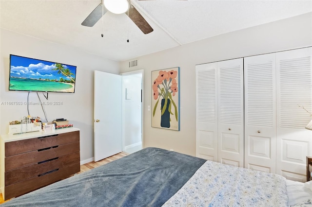 bedroom featuring ceiling fan, a closet, and light hardwood / wood-style flooring