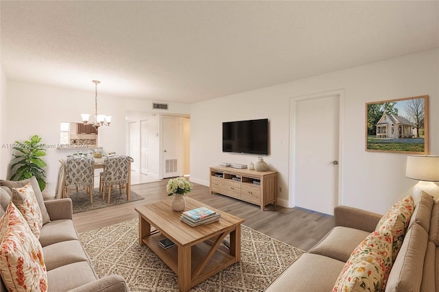 9460 Sunrise Lakes Blvd Unit 309, Sunrise, FL 33322 - living room with a chandelier, light wood-style floors, and baseboards