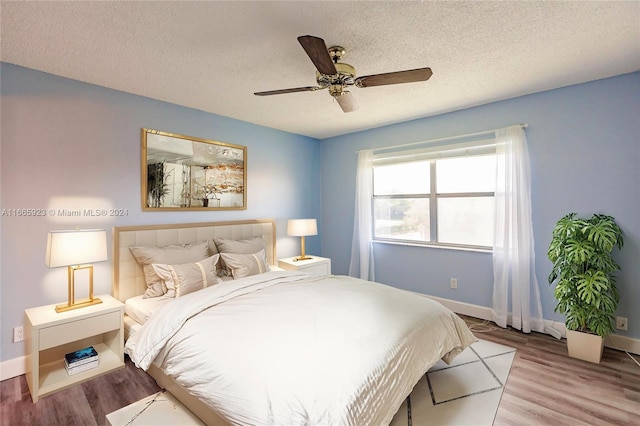 9460 Sunrise Lakes Blvd Unit 309, Sunrise, FL 33322 - bedroom featuring baseboards, a textured ceiling, wood finished floors, and ceiling fan