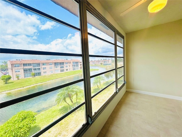 9460 Sunrise Lakes Blvd Unit 309, Sunrise, FL 33322 - unfurnished sunroom with baseboards, a water view, and tile patterned floors