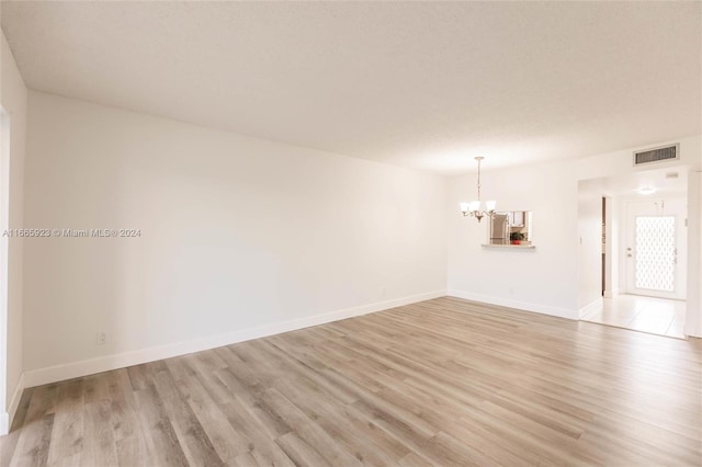9460 Sunrise Lakes Blvd Unit 309, Sunrise, FL 33322 - empty room featuring a chandelier, light wood-type flooring, and baseboards