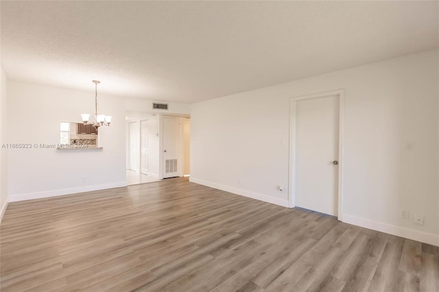 9460 Sunrise Lakes Blvd Unit 309, Sunrise, FL 33322 - spare room with a chandelier, wood finished floors, and baseboards