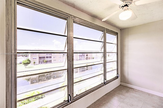 interior space featuring ceiling fan and a textured ceiling