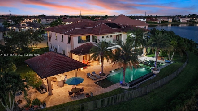 aerial view at dusk with a water view