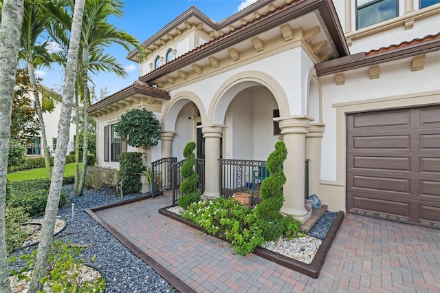 view of exterior entry with a garage