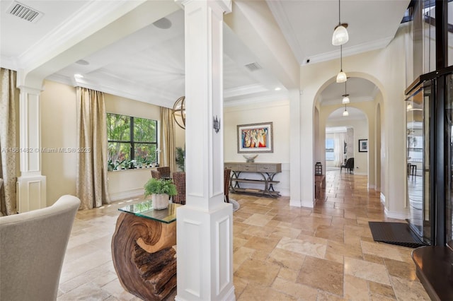 entrance foyer with crown molding and ornate columns