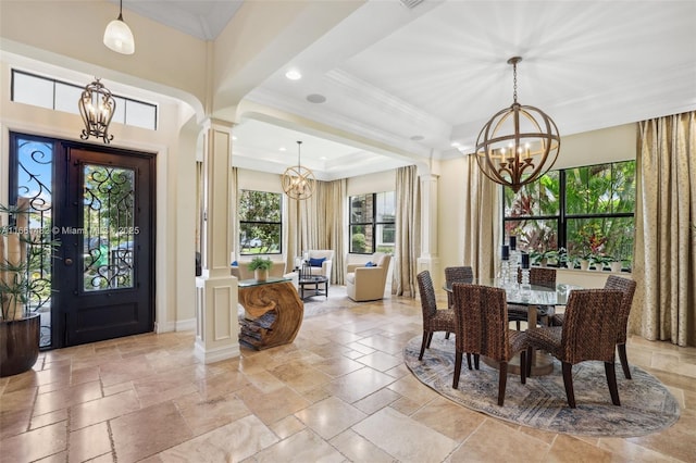 foyer featuring decorative columns and ornamental molding