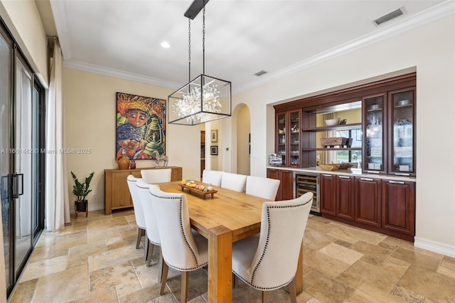 dining space with beverage cooler and ornamental molding