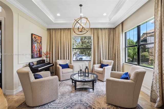 sitting room with a wealth of natural light and a tray ceiling