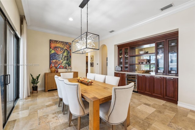 dining space featuring wine cooler and ornamental molding